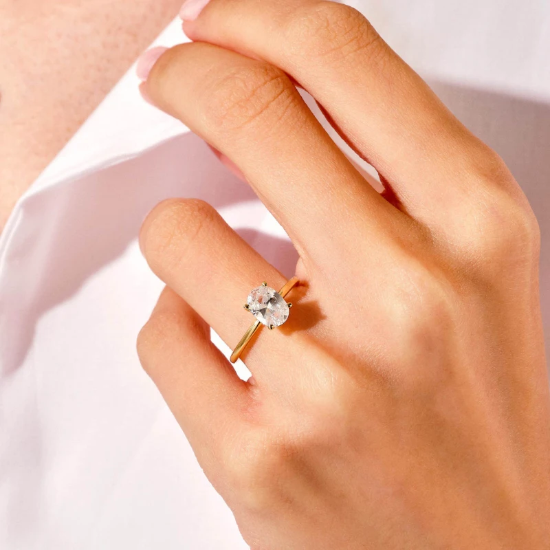Classic gold oval moissanite engagement ring for women with 1 to 5 carat stone and 4-prong S925 sterling silver setting – Mireli Jewelry