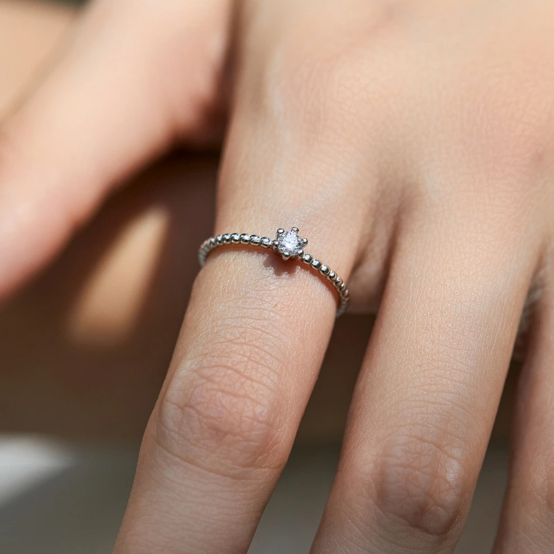 Dainty round moissanite solitaire ring with beaded sterling silver band by Lumi, elegant engagement jewelry gift