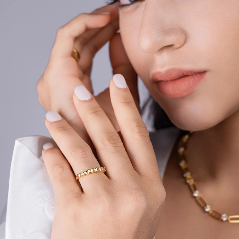 Elegant gold-plated sterling silver ring with heart detail and moissanite stones for women