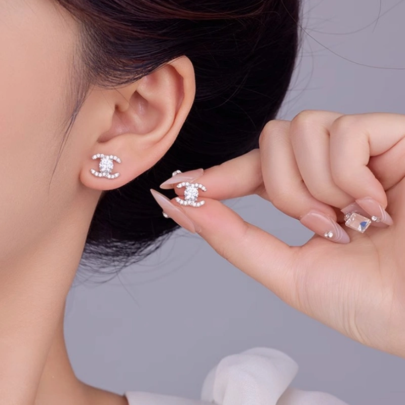 Crystal Embrace Double C Earrings – Sparkling moissanite logo-inspired stud earrings in 925 sterling silver, minimalist and elegant design for women
